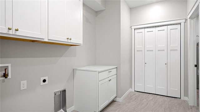 laundry room featuring electric dryer hookup, washer hookup, and cabinets