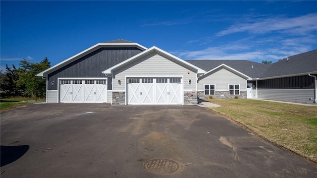 view of front of property with a garage and a front lawn