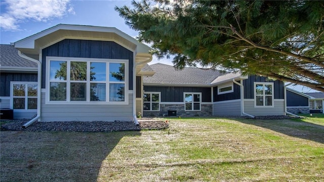 rear view of property with a lawn