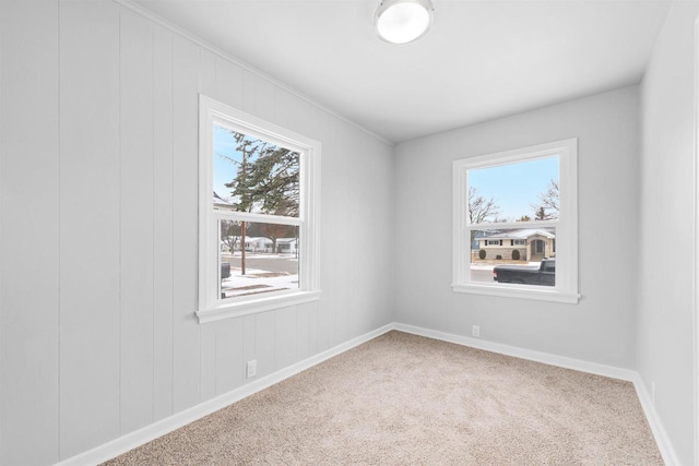 carpeted spare room with a healthy amount of sunlight