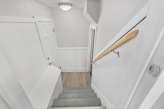 staircase with hardwood / wood-style flooring