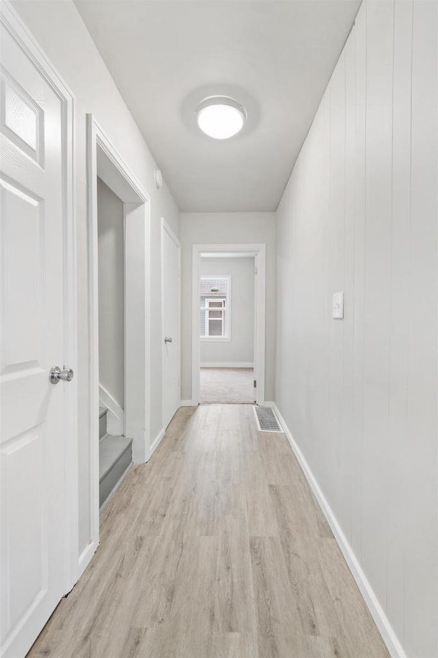 corridor with light hardwood / wood-style floors