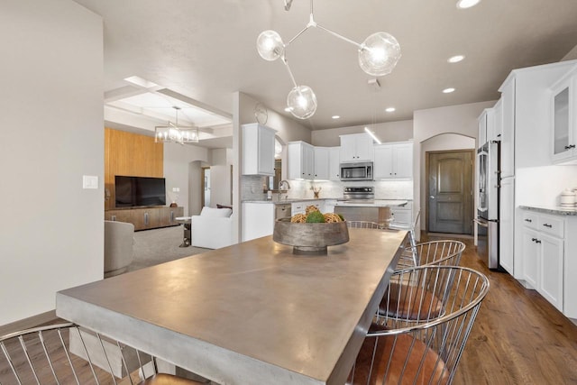 dining space featuring sink and dark hardwood / wood-style flooring