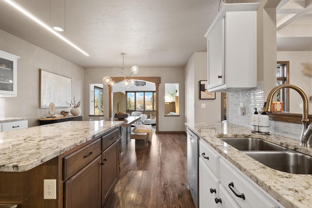 kitchen featuring dark hardwood / wood-style flooring, dishwasher, sink, and white cabinets