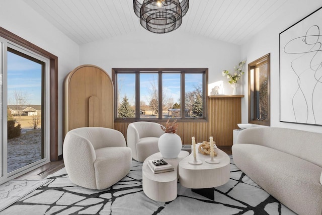 sitting room with vaulted ceiling, light wood-type flooring, and wood ceiling