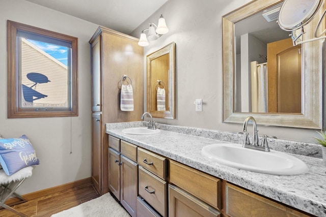 bathroom with hardwood / wood-style flooring and vanity