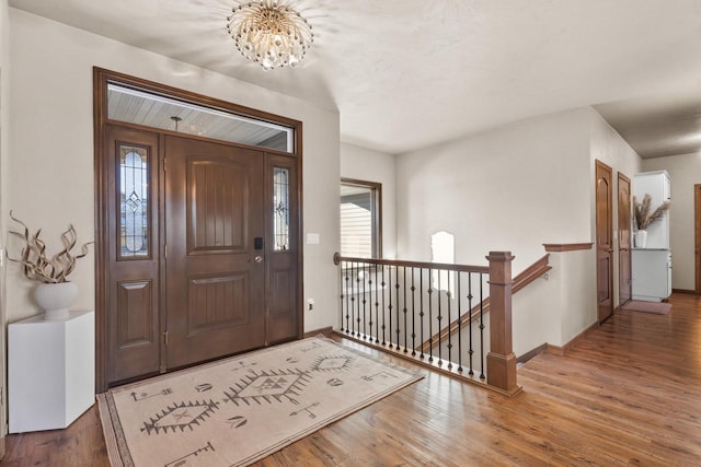 foyer featuring an inviting chandelier and hardwood / wood-style flooring