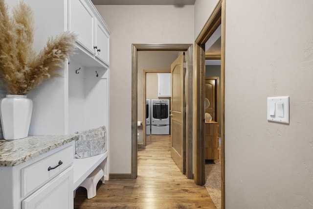 mudroom featuring washer / dryer and light hardwood / wood-style flooring