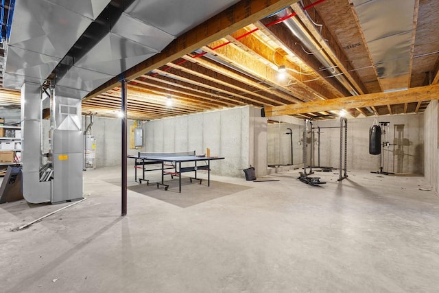 basement featuring heating unit and water heater