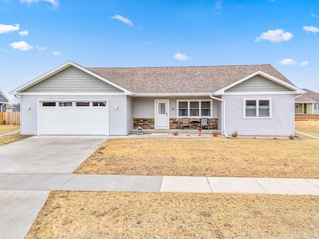 ranch-style home with a garage, covered porch, and a front lawn