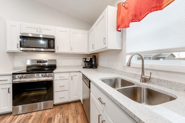 kitchen with white cabinetry, sink, and stainless steel appliances