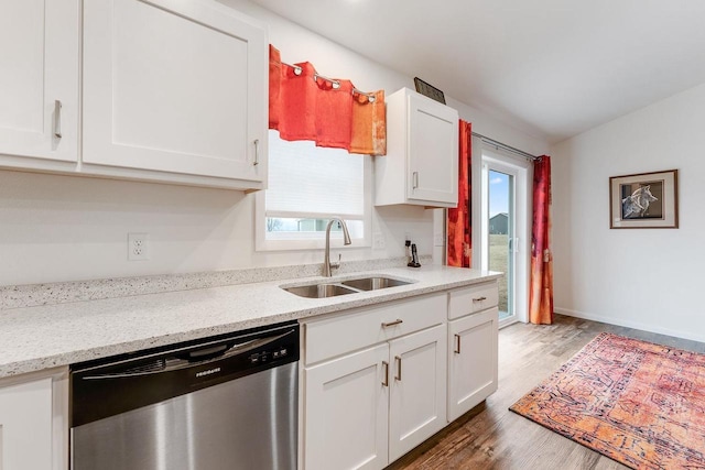 kitchen featuring white cabinetry, dishwasher, light stone countertops, and sink