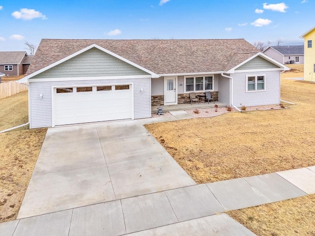 ranch-style home with a garage and a front yard