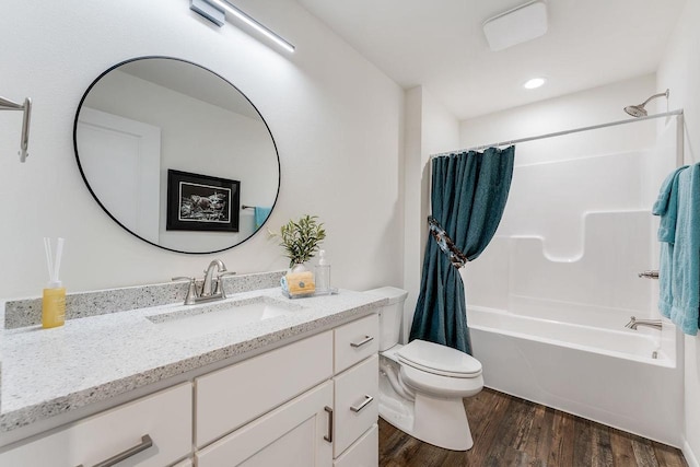 full bathroom with vanity, hardwood / wood-style floors, shower / bathtub combination with curtain, and toilet