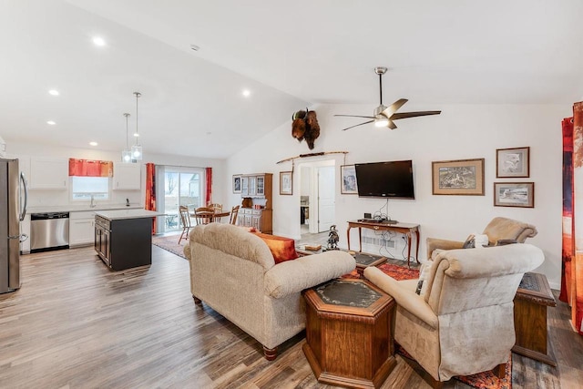 living room featuring wood-type flooring, lofted ceiling, and ceiling fan