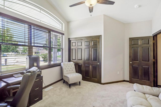 carpeted home office featuring ceiling fan and vaulted ceiling