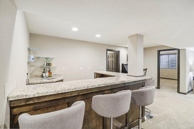 bar with sink and light colored carpet