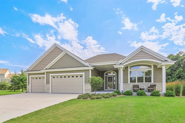 craftsman-style home featuring a garage and a front yard