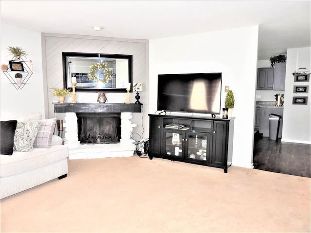 living room featuring carpet floors and a brick fireplace