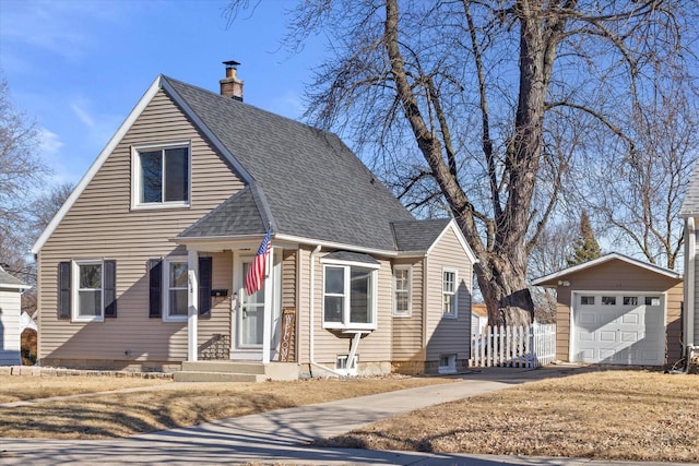 view of front of property featuring a garage and an outdoor structure