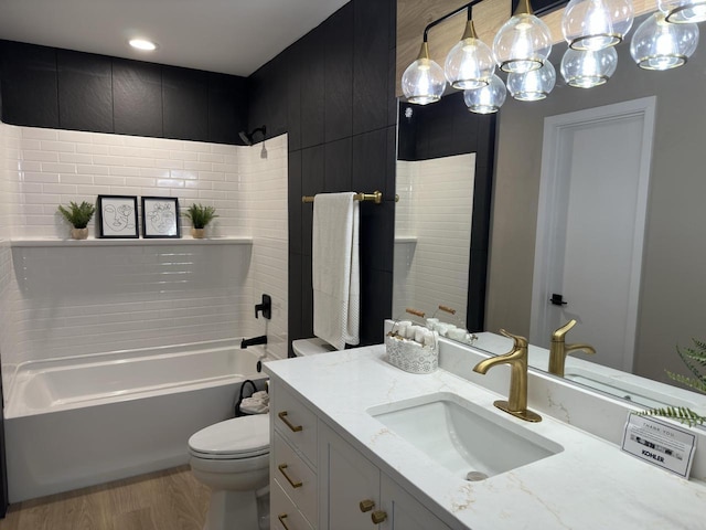 full bathroom featuring vanity, wood-type flooring, toilet, and shower / tub combination