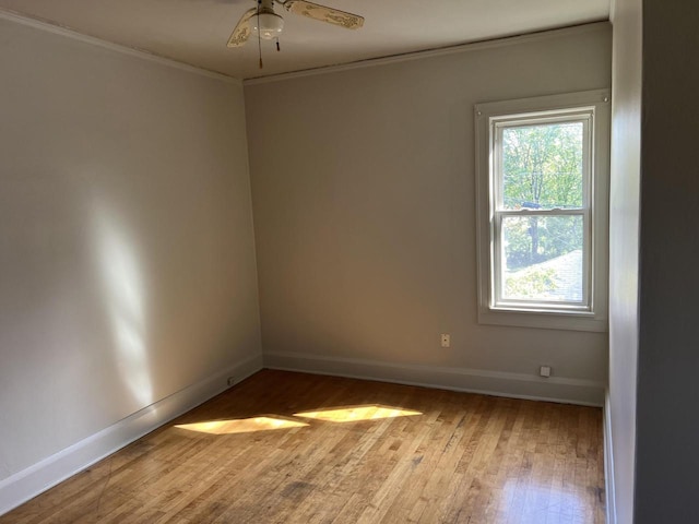 empty room with crown molding, ceiling fan, and light hardwood / wood-style flooring