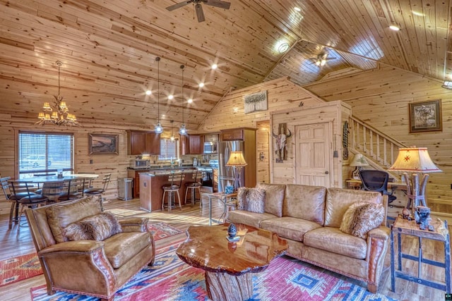 living room with wooden walls, ceiling fan with notable chandelier, and wooden ceiling