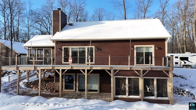 snow covered house with a deck