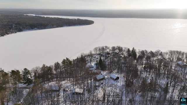 snowy aerial view featuring a water view