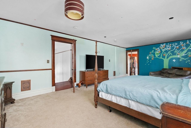 bedroom with ornamental molding and carpet