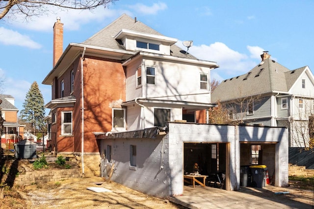 back of property featuring a garage