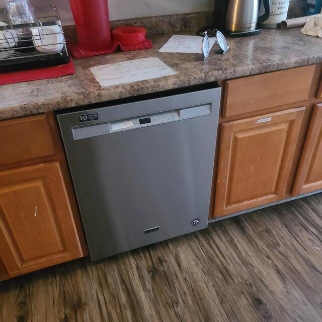 kitchen featuring dark hardwood / wood-style flooring and dishwasher