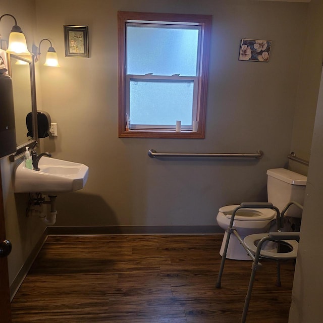 bathroom with wood-type flooring and toilet