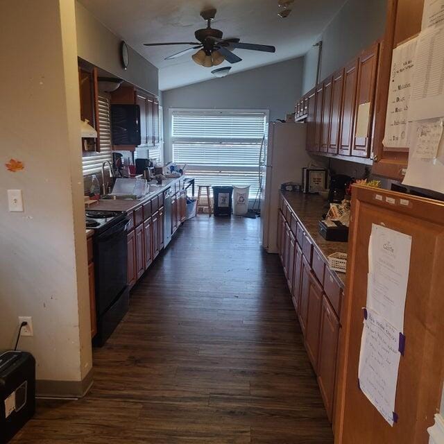 kitchen with dishwasher, sink, ceiling fan, dark wood-type flooring, and black / electric stove