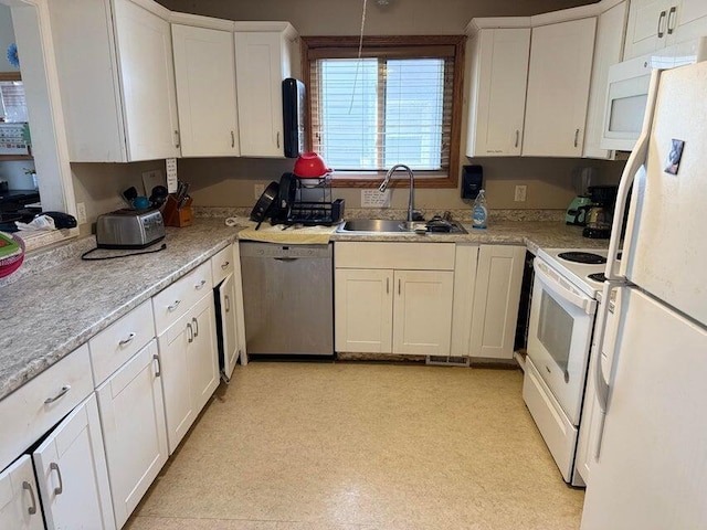 kitchen with pendant lighting, sink, white appliances, and white cabinets