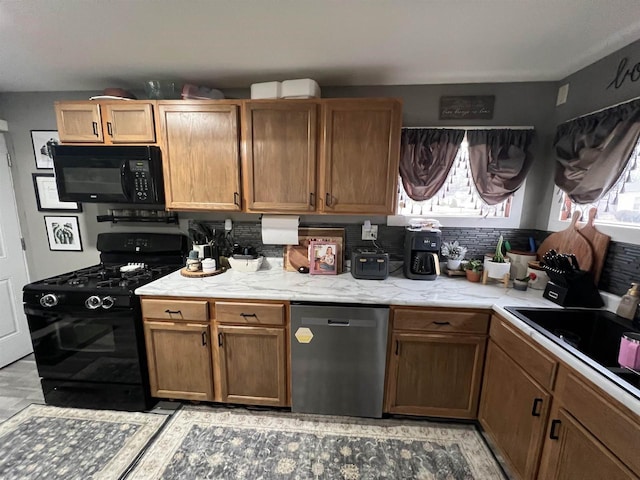 kitchen with tasteful backsplash, sink, and black appliances