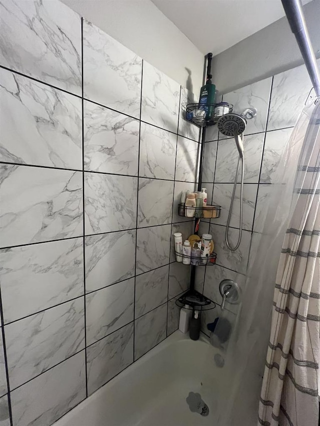 bathroom with shower / bathtub combination with curtain