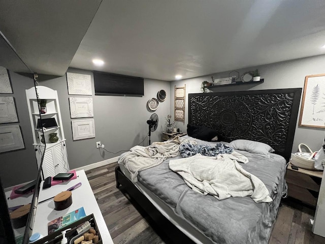 bedroom with dark hardwood / wood-style flooring