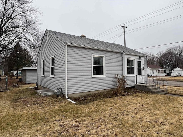 view of side of property with a lawn