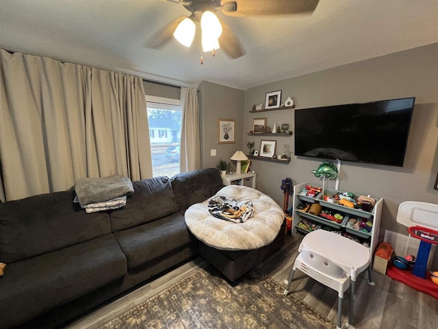 living room with ceiling fan and wood-type flooring