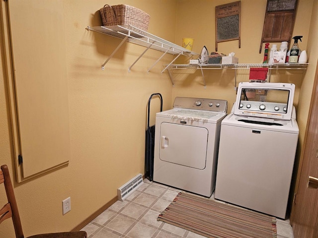 washroom with washing machine and clothes dryer