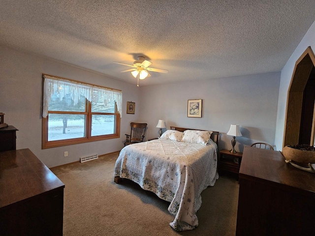 bedroom with a textured ceiling, carpet floors, and ceiling fan