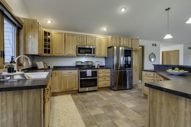 kitchen with sink, light tile patterned floors, stainless steel appliances, light brown cabinetry, and decorative light fixtures