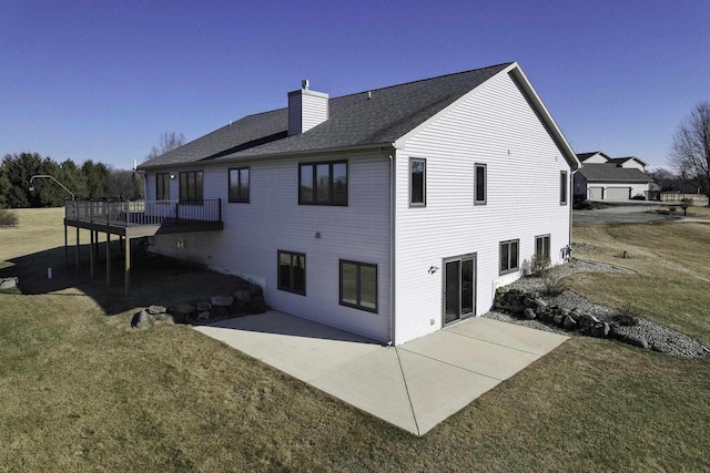 back of property featuring a wooden deck, a yard, and a patio area