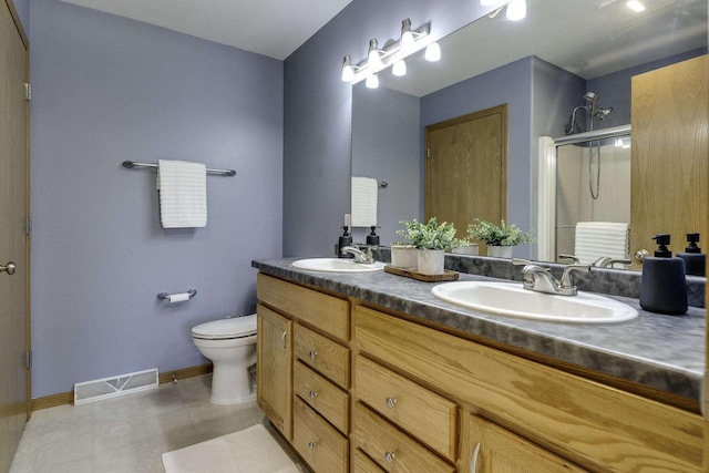 bathroom with tile patterned flooring, vanity, an enclosed shower, and toilet