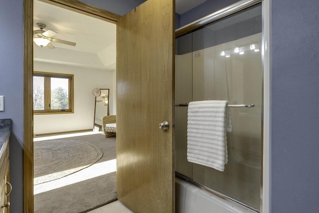 bathroom with ceiling fan and combined bath / shower with glass door