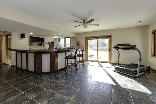 bar with ceiling fan and stainless steel fridge with ice dispenser