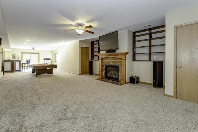 recreation room with pool table, ceiling fan, light carpet, and a fireplace