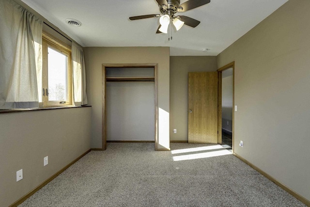 unfurnished bedroom featuring light colored carpet, ceiling fan, and a closet