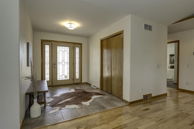 foyer entrance with light hardwood / wood-style floors